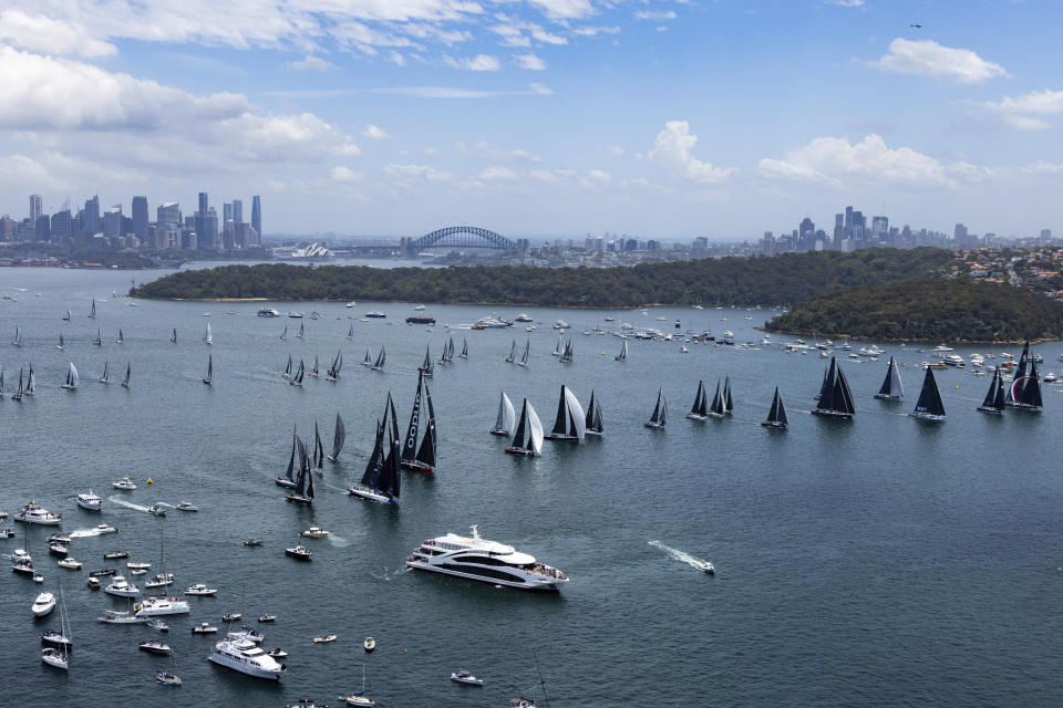 Competitors race to the start line to begin the Sydney Hobart yacht race in Sydney, Tuesday, Dec. 26, 2023. The 630-nautical mile race has more than 100 yachts starting in the race to the island state of Tasmania. (Andrea Francolini/Rolex/CYCA via AP)