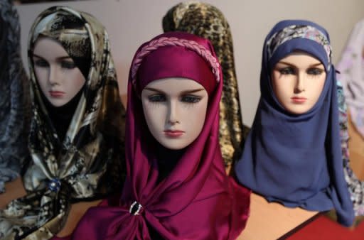 Headscarves on mannequins at the Islamic fashion exhibition in Tehran in March. Female booth attendants at an international trade fair and shops selling men's ties have become targets in a strict crackdown by Tehran police on clothing deemed un-Islamic, Iranian media reported on Wednesday