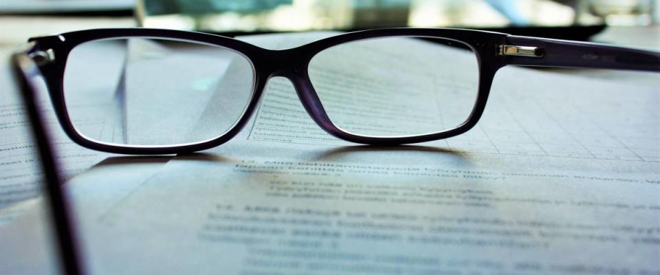 Reading glasses on a legal contract