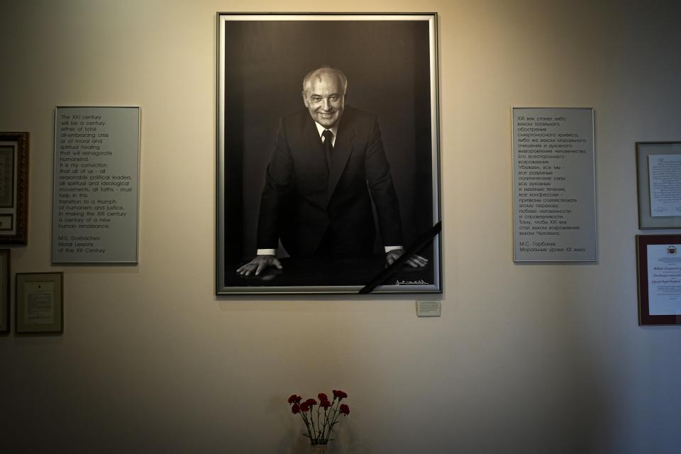 FILE - A portrait of the former Soviet President Mikhail Gorbachev and flowers are placed at his foundation's headquarters, a day after his passing, in Moscow, Russia, Wednesday, Aug. 31, 2022. The passing of Mikhail Gorbachev, the last leader of the Soviet Union and for many the man who restored democracy to then-communist-ruled European nations, was mourned Wednesday as the loss of a rare leader who changed the world and for a time gave hope for peace among the superpowers. (AP Photo/Alexander Zemlianichenko, File)