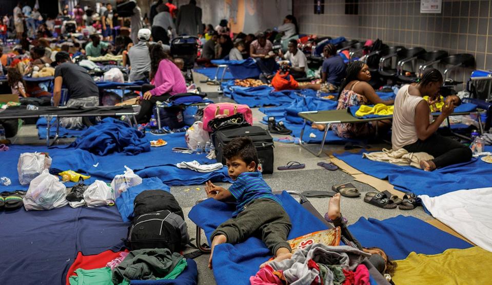 Migrants on the floor and on cots at a makeshift shelter at Chicagos OHare International Airport