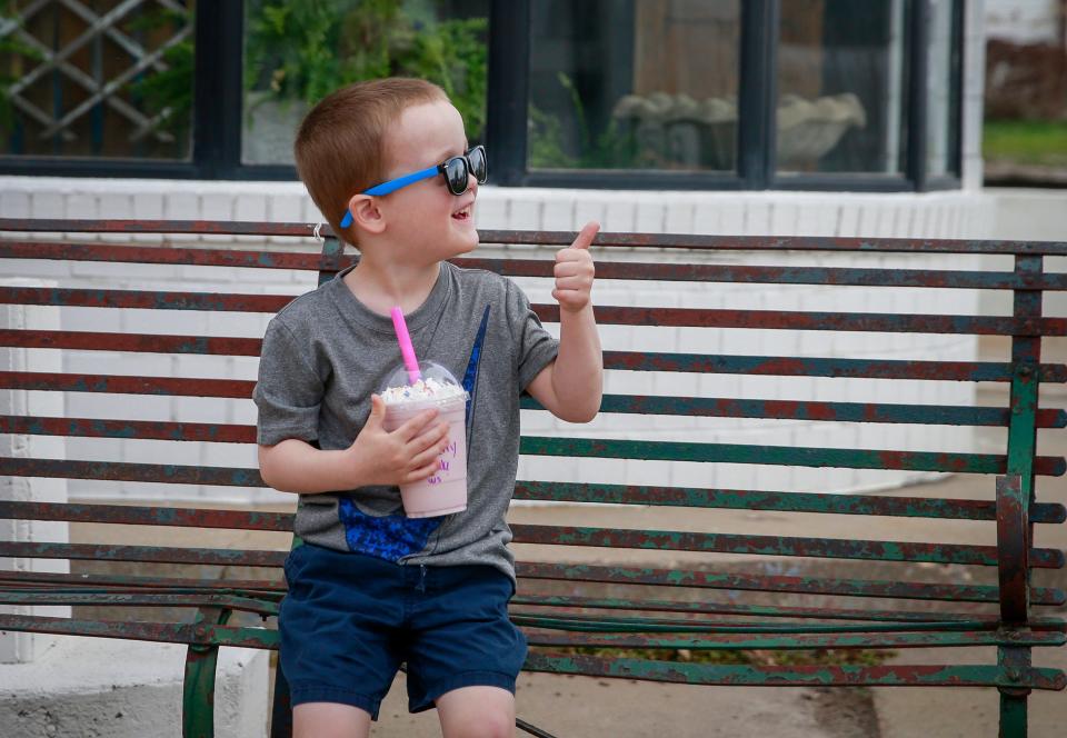 Peyton Fagen, 4, of Keota, gives a thumbs-up to the owners of the Rural Revival coffee truck after taking a taste of his smoothie on Saturday, April 23, 2022.