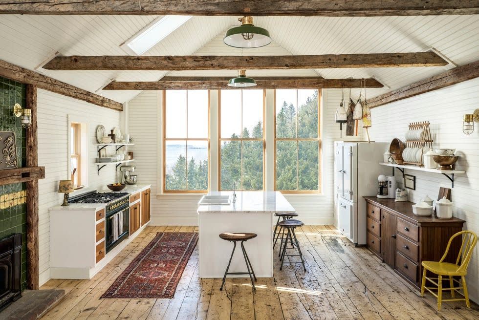 white farmhouse kitchen with wood floors and ceiling beams