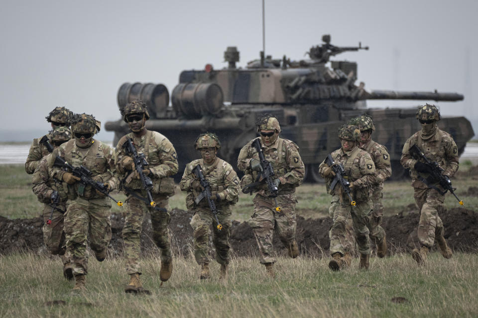 FILE - Servicemen of the United States 101 Airborne Division run during an exercise at the Mihail Kogalniceanu Air Base, near the Black Sea port of Constanta, Romania, Friday, March 31, 2023. Russia’s armed forces are bruised but by no means beaten in the war in Ukraine, a top NATO military officer said Monday, as he laid out the biggest revamp to the organization’s military plans since the Cold War should Moscow dare to widen the conflict. (AP Photo/Vadim Ghirda, File)