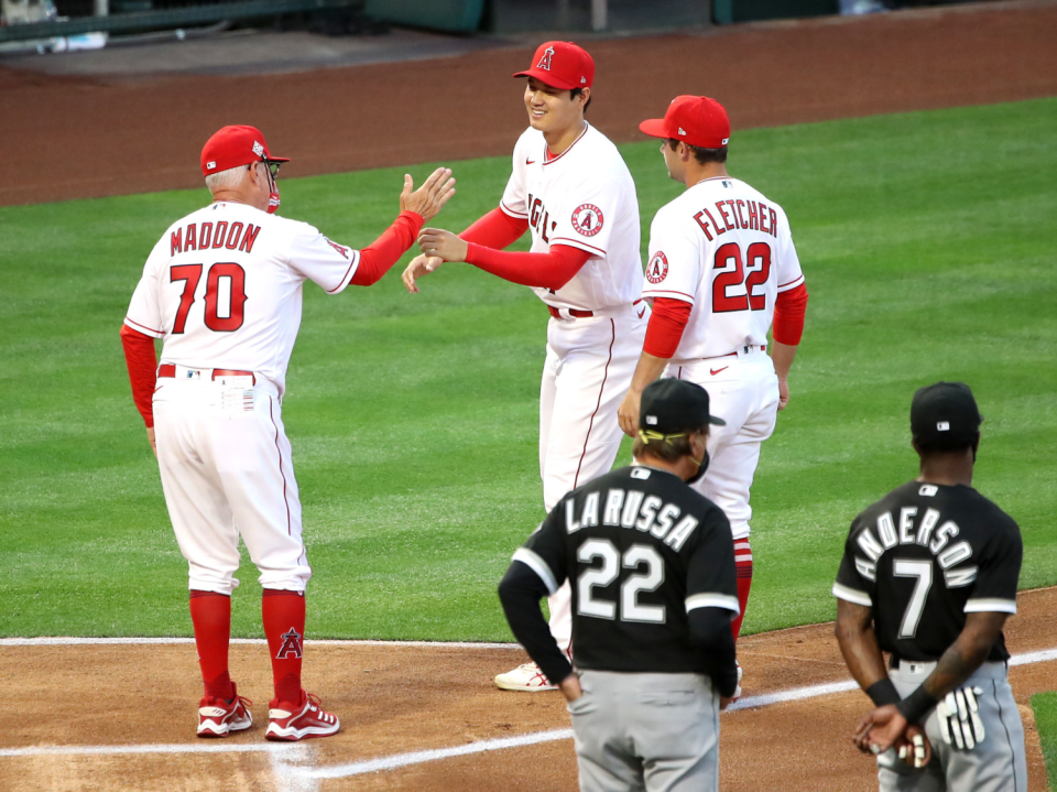 Angels manager Joe Maddon, left, greets pitcher Shohei Ohtani.