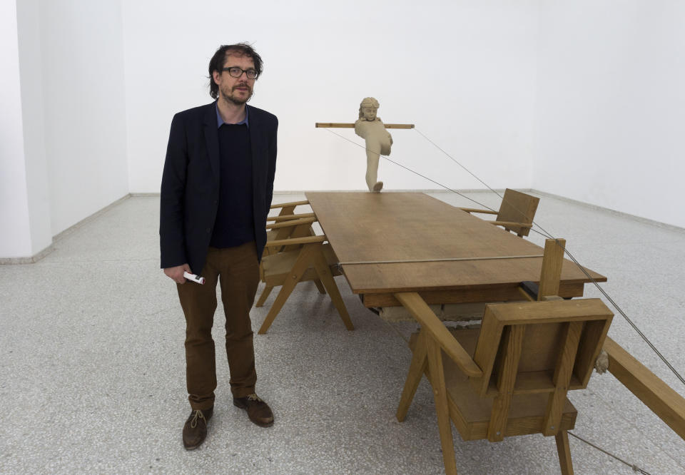 In this photo taken Wednesday, May 29, 2013, artist Mark Manders poses in front of his sculpture 'Mind study', inside the Dutch Pavilion during a preview of the 55th edition of the Venice Biennale of Arts in Venice, northern Italy. (AP Photo/Domenico Stinellis)
