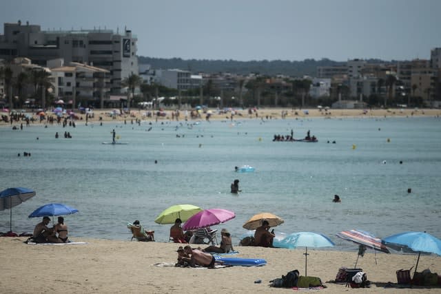 Sunbathers enjoy the beach in the Balearic Islands capital of Mallorca