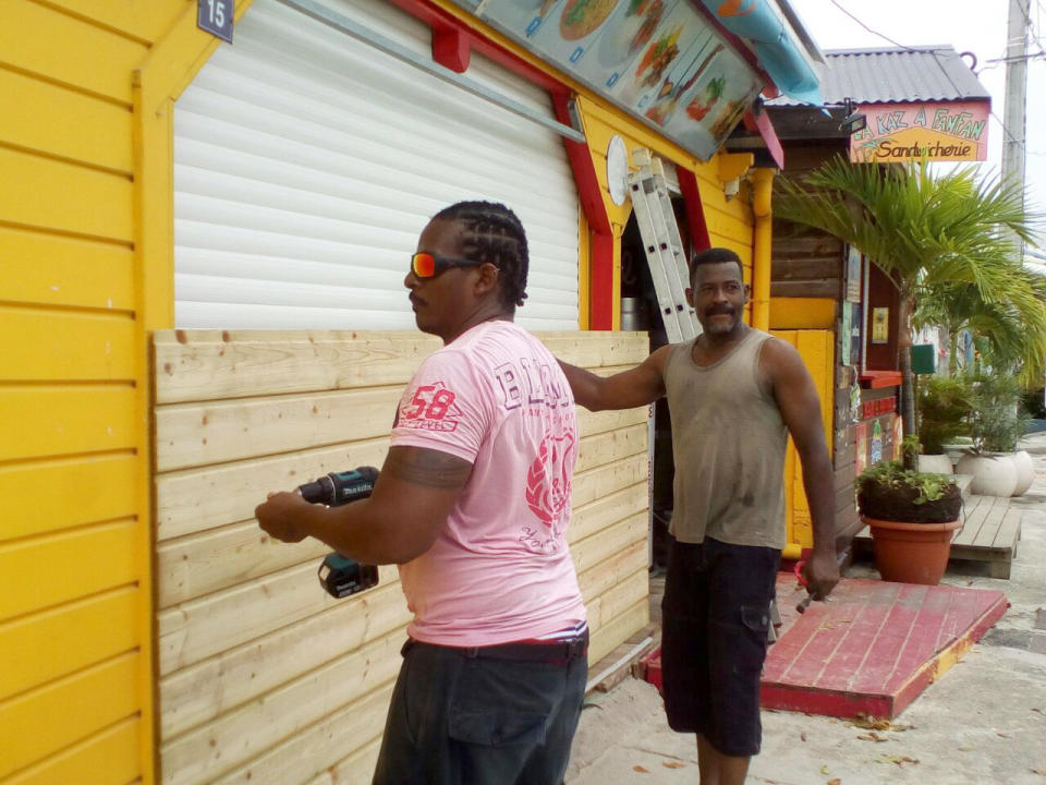 <p>Men board up buildings ahead of Hurricane Maria in Sainte-Anne on the French Caribbean island of Guadeloupe, Monday, Sept. 18, 2017. (Photo: Dominique Chomereau-Lamotte/AP) </p>