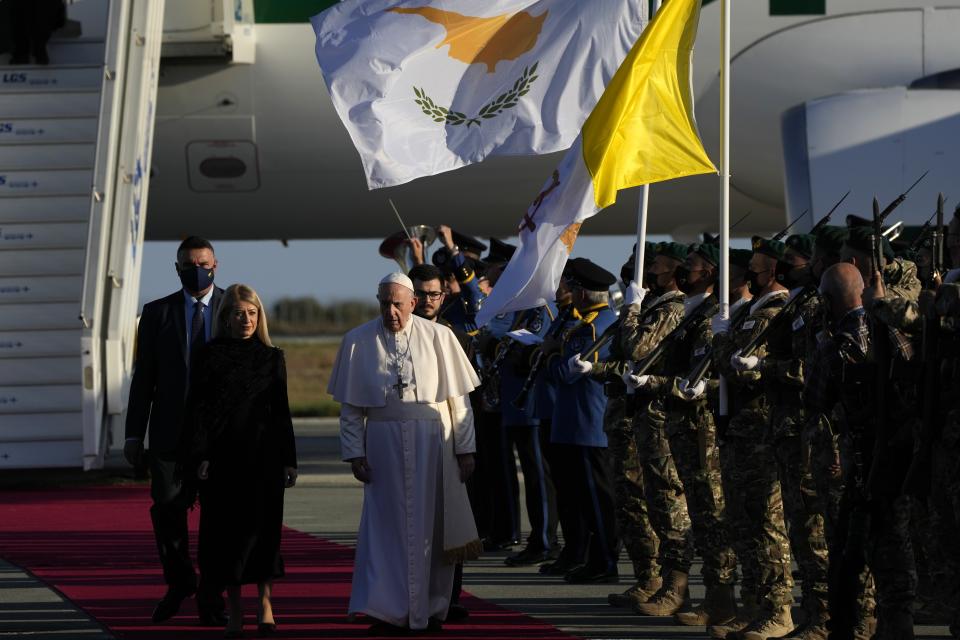 Pope Francis arrives at the airport in Larnaca, Cyprus, Thursday, Dec. 2, 2021. Pope Francis' trip to Cyprus and Greece is drawing new attention to the plight of migrants on Europe's borders and the disconnect between Francis' Gospel-driven call for countries to welcome and integrate them and front-line governments that are increasingly unwilling or unable to let them in. (AP Photo/Alessandra Tarantino)