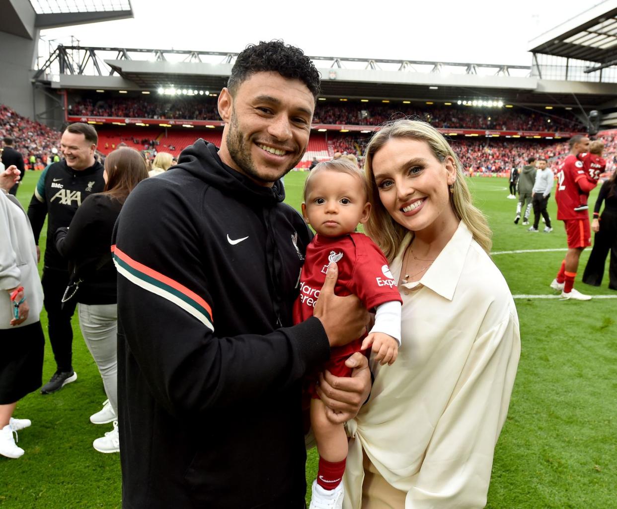 alex oxlade chamberlain of liverpool posing for a photograph with perrie edwards and their baby boy at the end of the premier league match