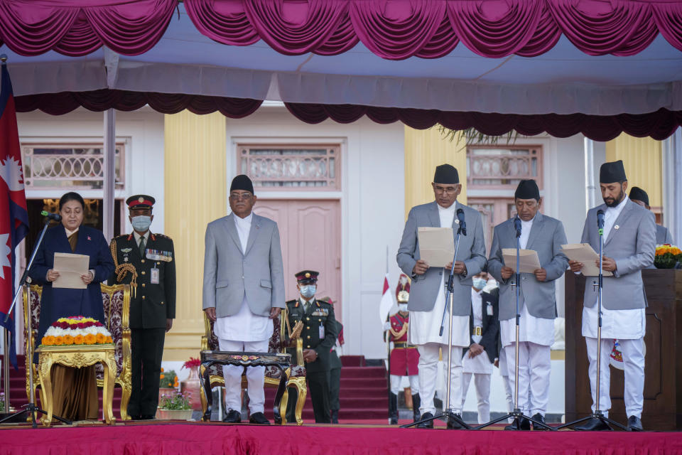 Nepal's newly elected three deputy prime minister's, from right, Rabi Lamichhane, Narayan Kaji Shrestha and Bishnu Paudel are being sworn in by President Bidhya Devi Bhandari, left, as newly appointed prime minister Pushpa Kamal Dahal, second left, looks on at the President House during a ceremony in Kathmandu, Nepal, Monday, Dec. 26, 2022. Dahal has appointed three deputies and four other ministers in the Cabinet that is expected to be expanded in the next few days to accommodate more members from the seven parties in the new coalition government. (AP Photo/Niranjan Shrestha)