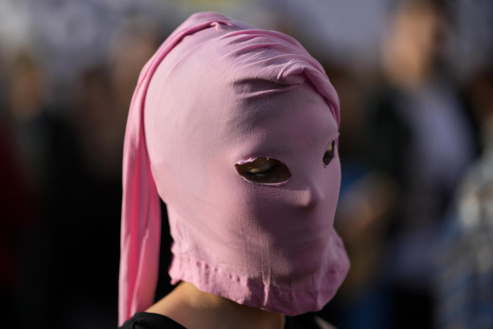 A demonstrator waits for the start of a march to celebrate International Transgender Day of Visibility in Lisbon, Friday, March 31, 2023. (AP Photo/Armando Franca)