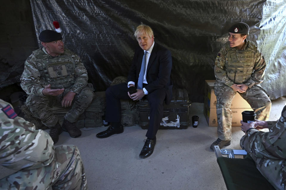 Britain's Prime Minister Boris Johnson meets with military personnel on Salisbury Plain training area near Salisbury, England, Thursday, Sept. 19, 2019. British Prime Minister Boris Johnson was accused by a one of the country’s former leaders of a “conspicuous” failure to explain why he suspended Parliament for five weeks, as a landmark Brexit case at the U.K. Supreme Court came to a head on Thursday. (Ben Stansall/Pool Photo via AP)