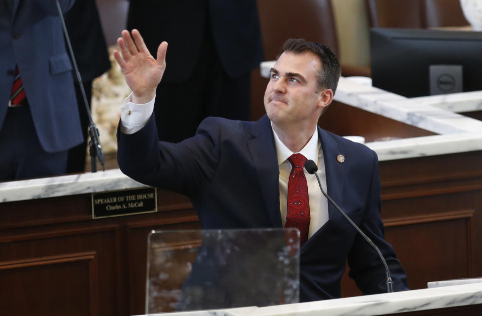 Oklahoma Gov. Kevin Stitt waves to the balcony as he delivers the State of the State in Oklahoma City, Monday, Feb. 4, 2019. (AP Photo/Sue Ogrocki)