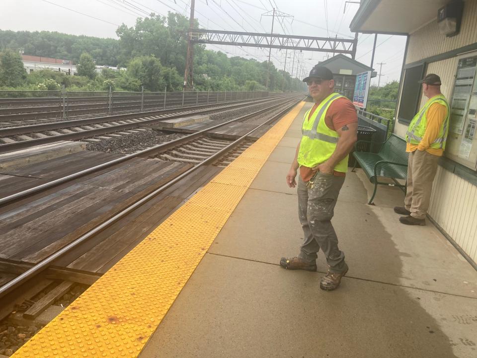 Chris Denzii, a SEPTA painter, watches Monday for an approaching Trenton Line Silverliner at the Cornwells Heights station in Bensalem. Employees were recruited from their usual positions to help the extra rush of commuters taking suburban train lines due to the bridge collapse Sunday June 11. "We're ambassadors helping out," Denzii said.