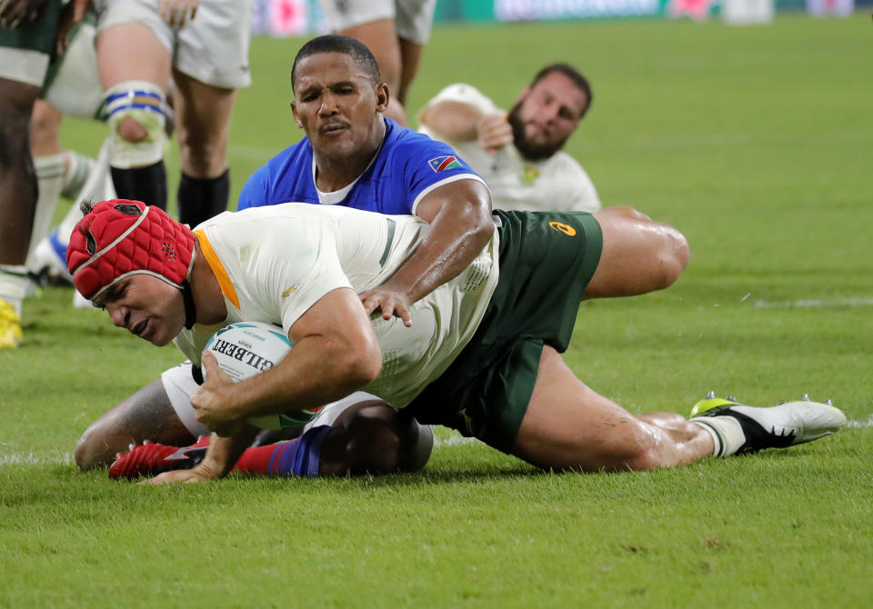 South Africa's Schalk Brits scores a try as he is tackled by Namibia's Eugene Jantjies during the Rugby World Cup Pool B game at the City of Toyota Stadium between South Africa and Namibia in Toyota City, Japan, Saturday, Sept. 28, 2019. (AP Photo/Christophe Ena)