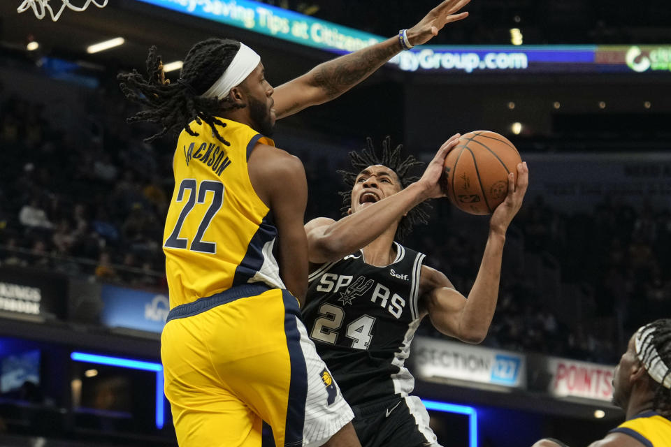 San Antonio Spurs guard Devin Vassell (24) shoots around Indiana Pacers forward Isaiah Jackson (22) during the first half of an NBA basketball game in Indianapolis, Friday, Oct. 21, 2022. (AP Photo/AJ Mast)