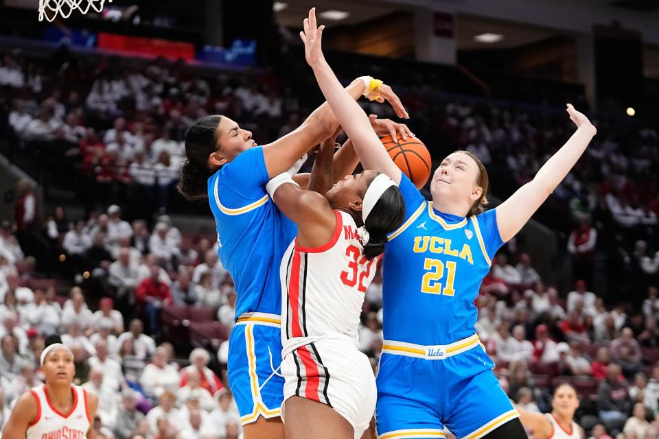 Dec 18, 2023; Columbus, OH, USA; UCLA Bruins center Lauren Betts (51) and forward Lina Sontag (21) block the shot of Ohio State Buckeyes forward Cotie McMahon (32) during the first half of the NCAA women’s basketball game at Value City Arena.