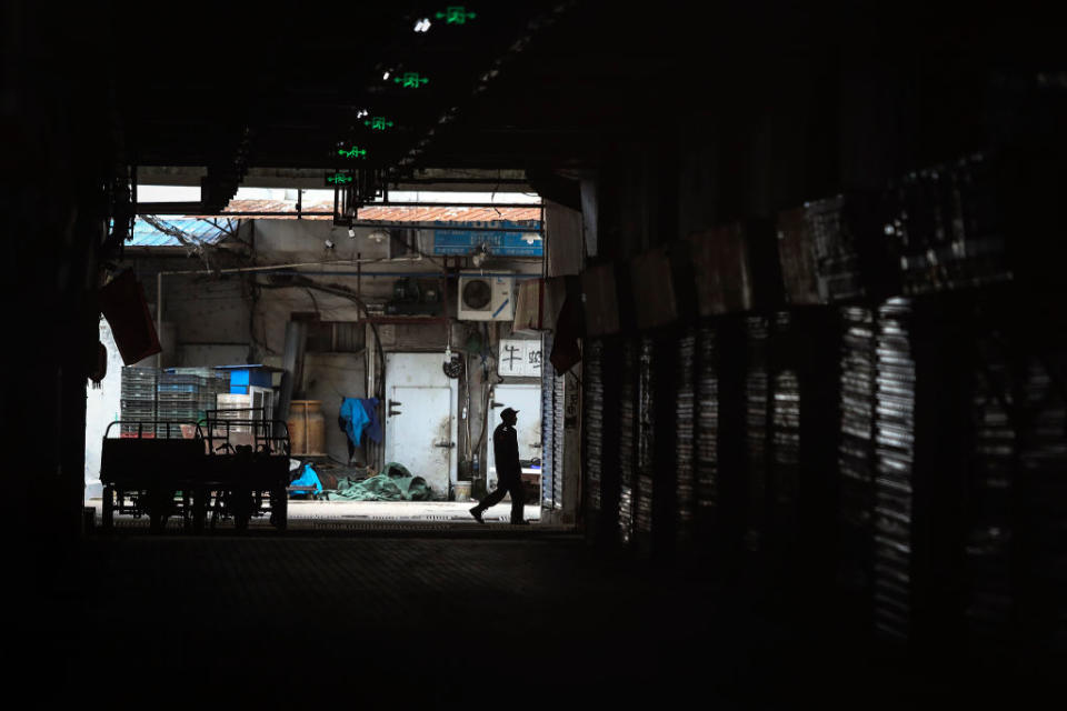 An employee walks past the closed Huanan Seafood Wholesale Market, which has been linked to cases of coronavirus, on Jan. 17, 2020 in Wuhan, Hubei province, China. Local authorities have confirmed that a second person in the city has died of a pneumonia-like virus since the outbreak started in December. | Getty Images