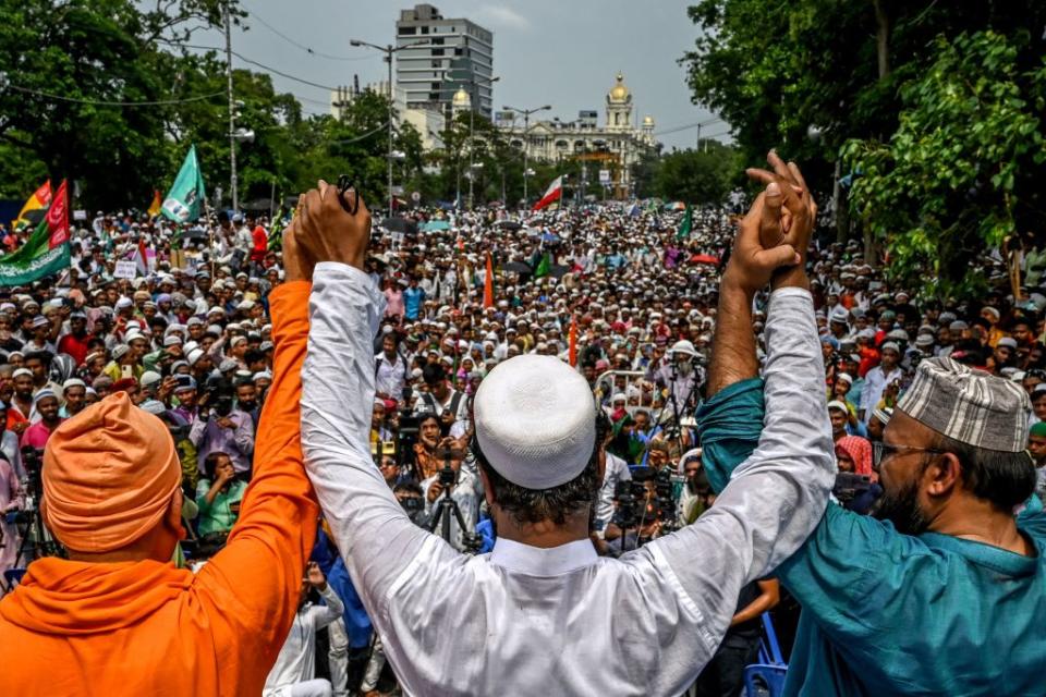 Muslim activists along with a member from Hindu organization Ramakrishna Mission, left, take part in a unity rally to promote communal harmony in Kolkata on June 14, 2022.<span class="copyright">Dibyangshu Sarkar—AFP/Getty Images</span>