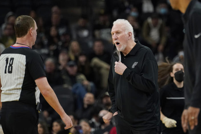 San Antonio Spurs head coach Gregg Popovich, right, questions a call during an NBA basketball game against the Houston Rockets, Wednesday, Jan. 12, 2022, in San Antonio. (AP Photo/Eric Gay)