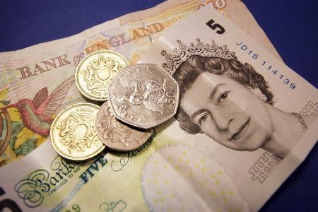 Some British sterling money in coins and bank notes is seen September 2, 2005. BANKG REUTERS/Catherine Benson