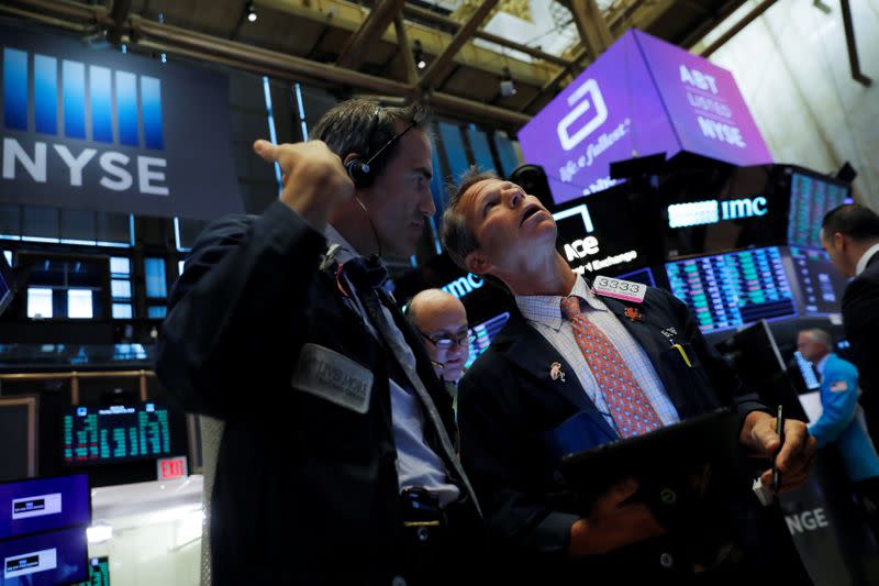 Traders work on the trading floor at the New York Stock Exchange (NYSE) at the opening of the market in New York City