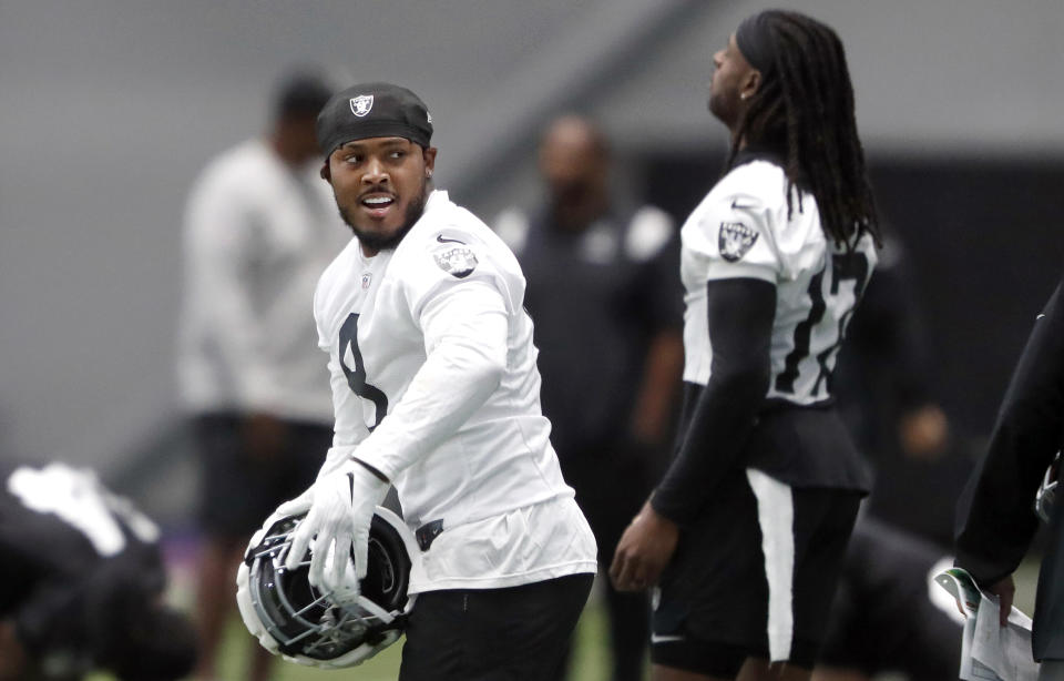 Las Vegas Raiders running back Josh Jacobs, left, warms up during practice at the Raiders Headquarters/Intermountain Health Performance Center, Wednesday, Aug. 30, 2023, in Henderson, Nev. (Steve Marcus/Las Vegas Sun via AP)