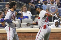 Atlanta Braves' Abraham Almonte, right, and Dansby Swanson celebrate after scoring on Almontes' two-run home run during the third inning of the team's baseball game against the New York Mets, Tuesday, July 27, 2021, in New York. (AP Photo/Mary Altaffer)