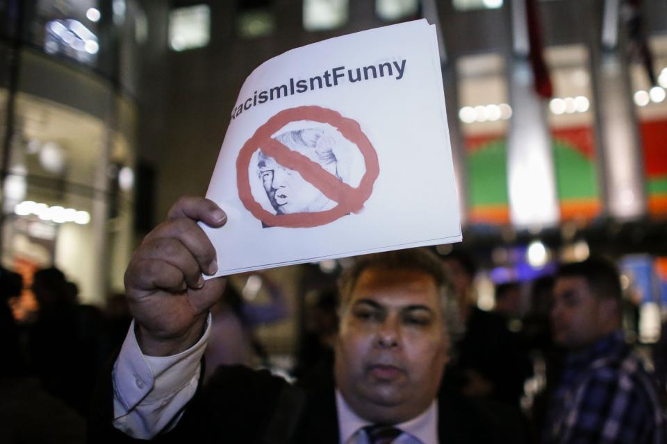 People protest in  front of NBC studios while they are calling for the network to rescind the invitation to Donald Trump to host Saturday Night Live show on November 4, 2015 in New York.