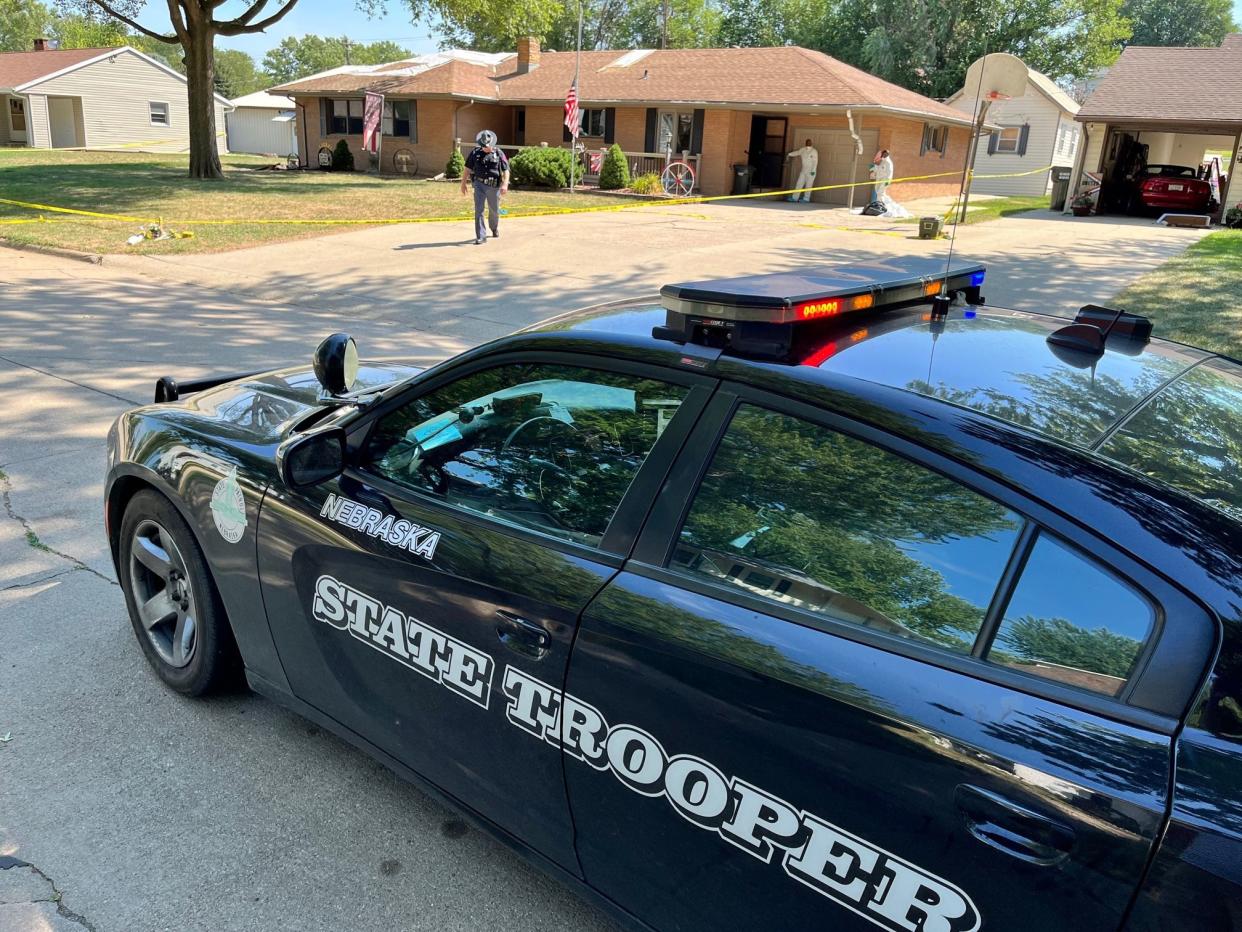 A Nebraska state police vehicle stis parked outside the Twiford family home in Laurel.