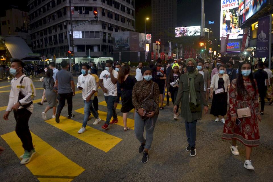 People hanging around Bukit Bintang on New Year’s Eve, December 31,2020. — Picture by Miera Zulyana