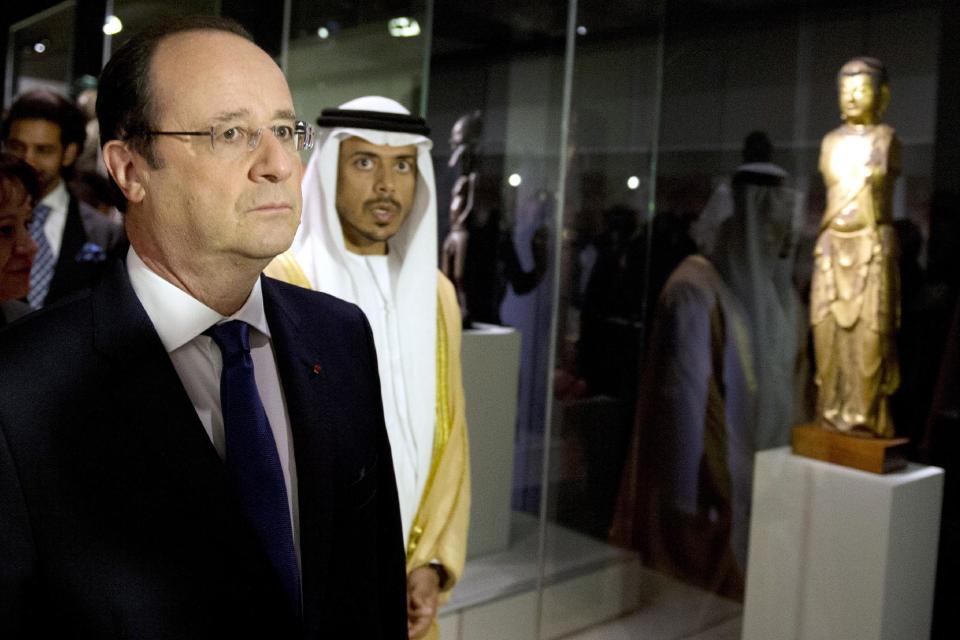 French President Francois Hollande, left, talks with Sheikh Sultan Bin Tahnoon Al Nathyan, Abu Dhabi authority president for tourism and culture, as they visit the exhibition 'Birth of a Museum', at the Louvre museum, Tuesday April 29, 2014, in Paris. The 'Birth of a Museum' exposition presents paintings, sculptures, and other artworks that the famous French Louvre museum will send to the new Louvre museum branch in Abu Dhabi, in the United Arab Emirates, and which is expected to open in 2015. (AP Photo/Alain Jocard, Pool)