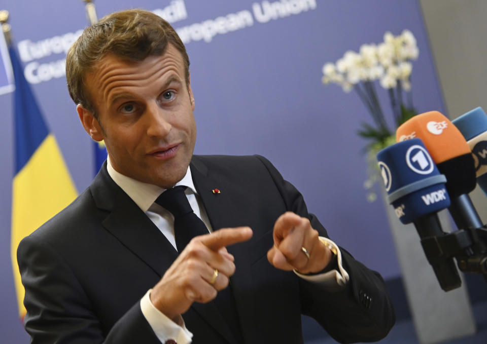 French President Emmanuel Macron speaks with the media during an EU summit at the Europa building in Brussels, Friday, June 21, 2019. European Union leaders have failed to back a plan to make the bloc's economy carbon neutral by 2050 in spite of promises to fight harder against climate change. (AP Photo/Riccardo Pareggiani)