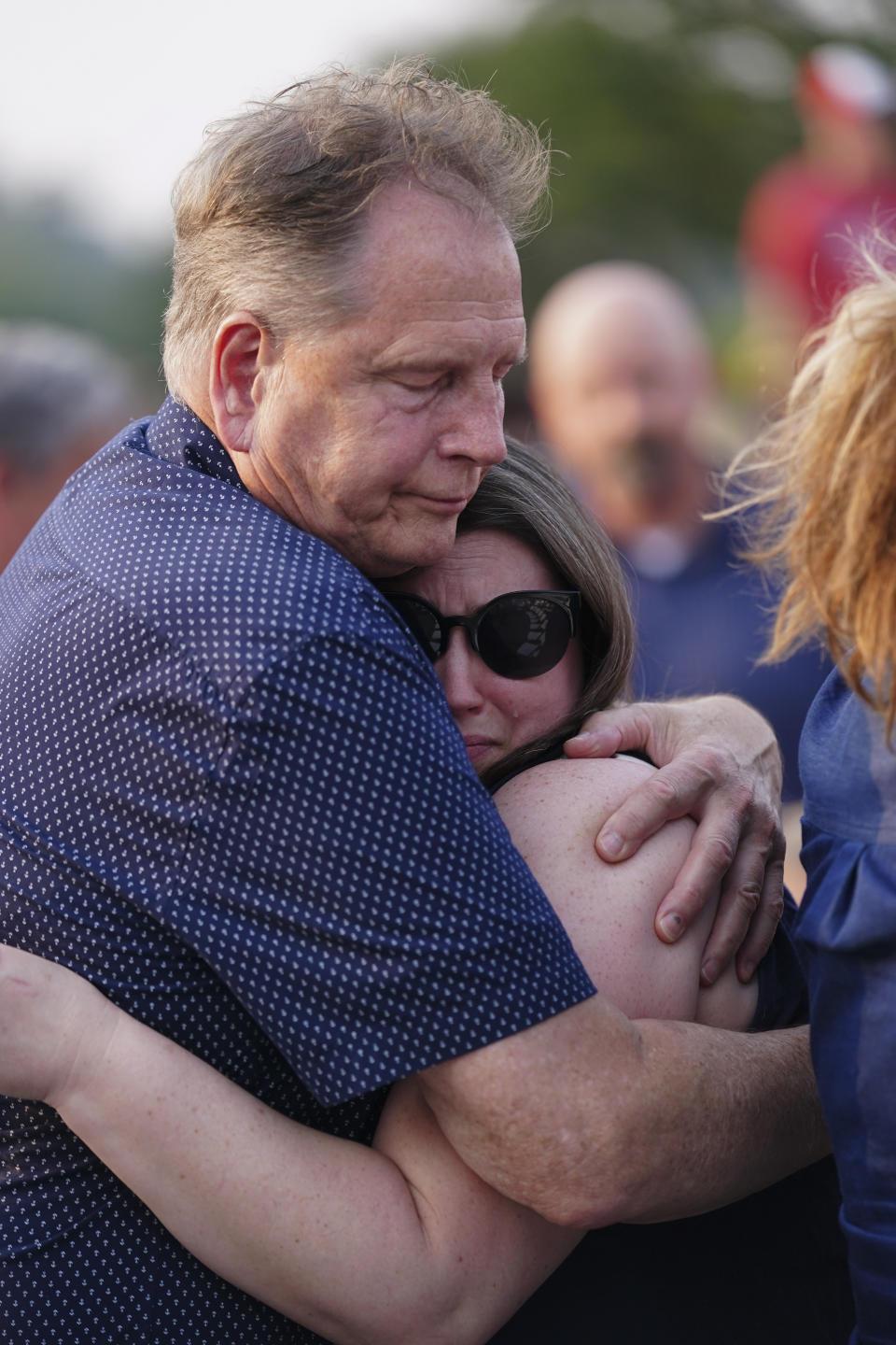 People embrace during a vigil for the victims of Saturday's mass shooting on Monday, July 17, 2023, in Hampton, Ga. (AP Photo/John Bazemore)