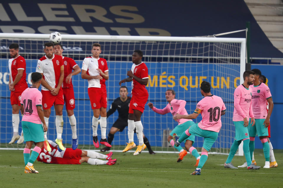 Barcelona's Lionel Messi, center right, shoots a free kick during the pre-season friendly soccer match between Barcelona and Girona at the Johan Cruyff Stadium in Barcelona, Spain, Wednesday, Sept. 16, 2020. (AP Photo/Joan Monfort)