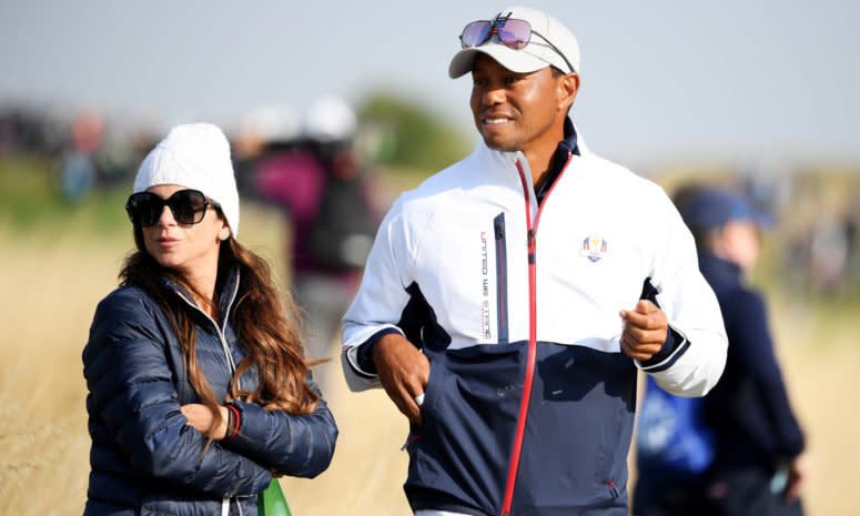 Tiger Woods walking with his girlfriend.