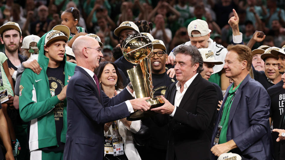 BOSTON, MASSACHUSETTS - JUNE 17: NBA Commissioner Adam Silver presents the Larry O'Brien Championship Trophy to Boston Celtics majority owner Wyck Grousbeck following Boston's 106-88 victory over the Dallas Mavericks in Game 5 of the 2024 NBA Finals at TD Garden on June 17, 2024 in Boston, Massachusetts. NOTICE TO USER: Users expressly acknowledge and agree that by downloading and/or using this photograph, users are deemed to have accepted the terms of the Getty Images License Agreement. (Photo by Elsa/Getty Images)