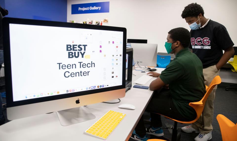 David Jamison, 18, shows off a logo he designed to John Holloway, 13, on Tuesday, Jan. 18, 2022, during the grand opening of a Best Buy Teen Tech Center in South Memphis. The center allows middle and high school aged kids to explore technology related to fashion, programming, photography, music production and recording and film.