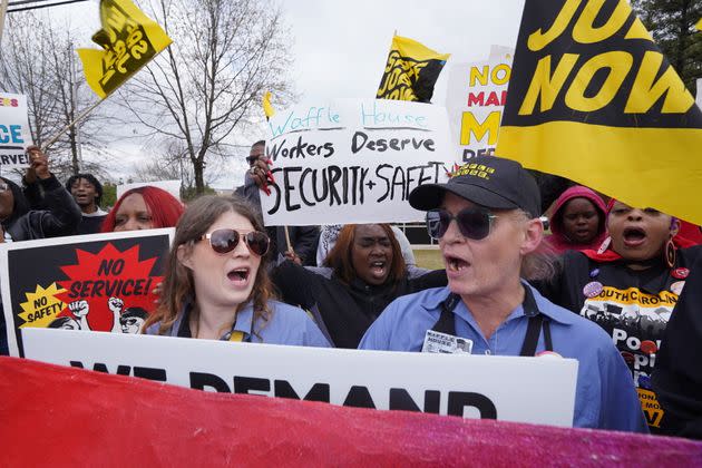 Waffle House workers Katie Giede, left, and Cindy Smith call for higher wages at a rally.