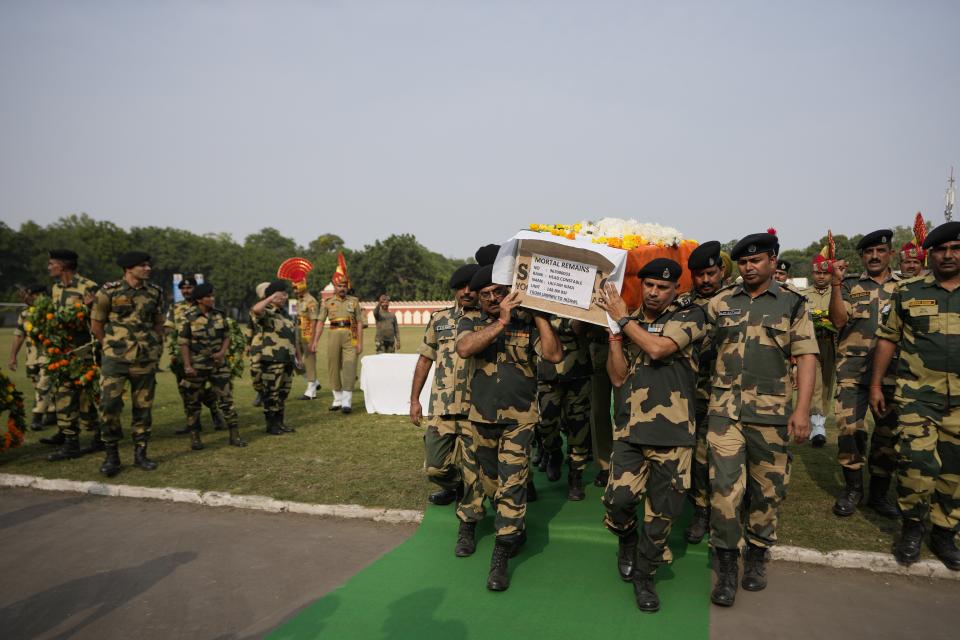 Indian Border Security Force (BSF) soldiers carry the coffin of their colleague Lal Fam Kima during a wreath-laying ceremony at the BSF headquarters in Jammu, India, Thursday, Nov.9, 2023. The Indian soldier was killed as Indian and Pakistani soldiers exchanged gunfire and shelling along their highly militarized frontier in disputed Kashmir. (AP Photo/Channi Anand)