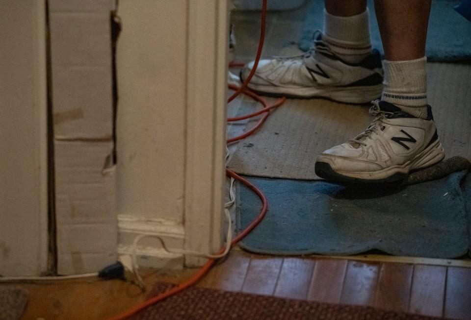 Because of a partial power outage in his unit at Willow Brook Apartments, leaving some rooms without electrical power, Tom McNamara has to run power strips and extension cords throughout his home. Multiple cords feed into one power strip in the bathroom in order to light his living room, seen on Thursday, July 13, 2023, in Indianapolis. 