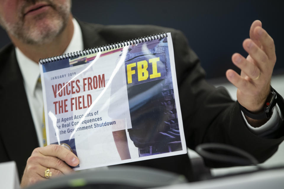 Tom O’Connor, president of the FBI Agents Association, holds a booklet with testimonies on how the government shutdown is affecting FBI agents, on Jan. 22, 2019, in Washington, D.C. (Photo: Al Drago/Bloomberg via Getty Images)