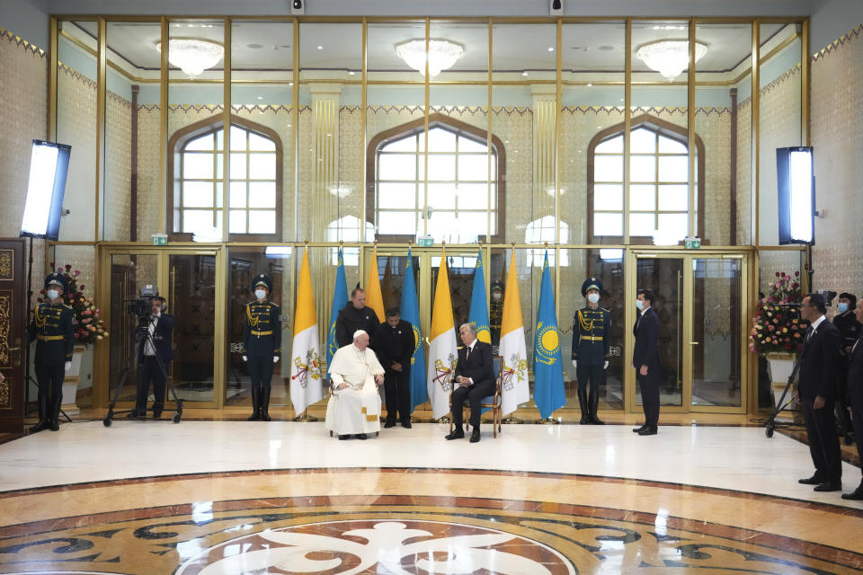 Pope Francis, left, meets the Kazakhstan's President Kassym-Jomart Tokayev as he arrives at Our-Sultan's International airport in Nur-Sultan, Kazakhstan, Tuesday, Sept. 13, 2022. Pope Francis begins a 3-days visit to the majority-Muslim former Soviet republic to minister to its tiny Catholic community and participate in a Kazakh-sponsored conference of world religious leaders. (AP Photo/Andrew Medichini)