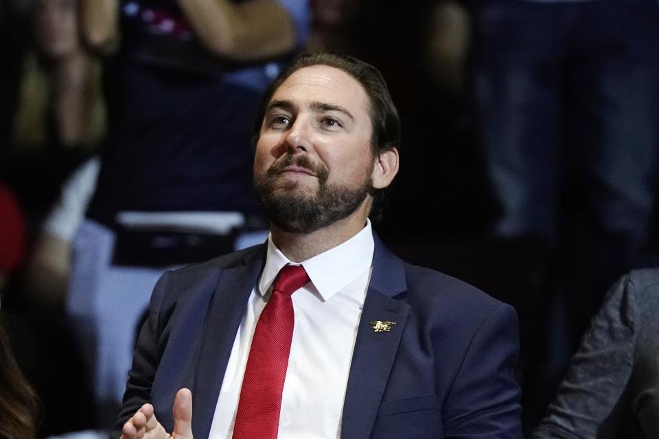 FILE - Eli Crane, a Republican candidate for the 2nd Congressional District in Arizona, is introduced by former President Donald Trump as Trump speaks at a "Save America" rally on July 22, 2022, in Prescott, Ariz. The vast 2nd Congressional District in Arizona will be a key factor in determining which political party has the majority in the state's delegation. Former Navy SEAL Eli Crane emerged from a crowded field of Republicans in the primary to take on Democratic U.S. Rep. Tom O'Halleran in the Nov. 8 general election. (AP Photo/Ross D. Franklin, File)