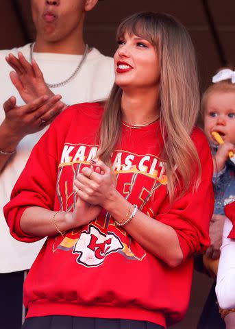 <p>Jamie Squire/Getty</p> Taylor Swift wearing Trav bracelet