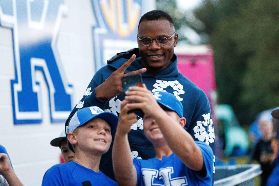 Former UK basketball star Oscar Tshiebwe takes photos with fans during the fourth inning of Sunday’s game against Indiana State at Kentucky Proud Park.