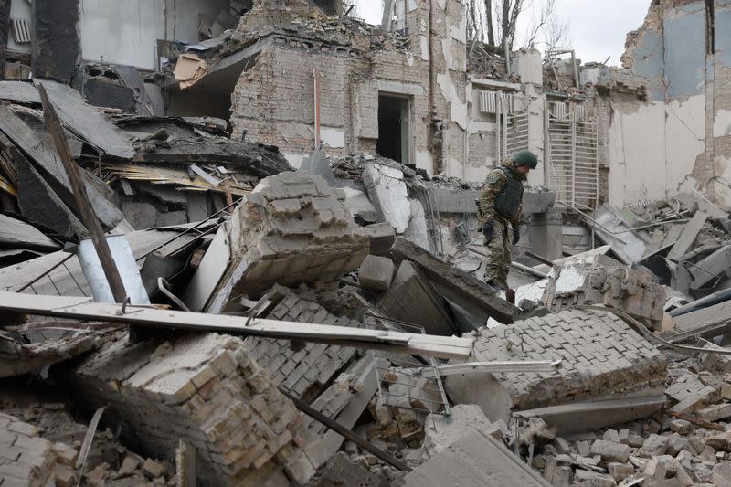 Rescuers work at the site of a building damaged by a Russian missile strike, in Kyiv