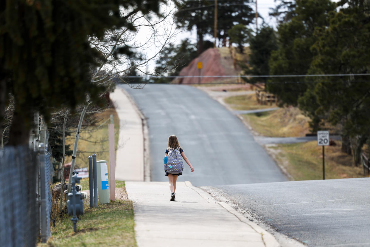 A girl walks home from Gateway Elementary School on April 12, 2023 in Woodland Park, Colo. (Michael Ciaglo for NBC News)