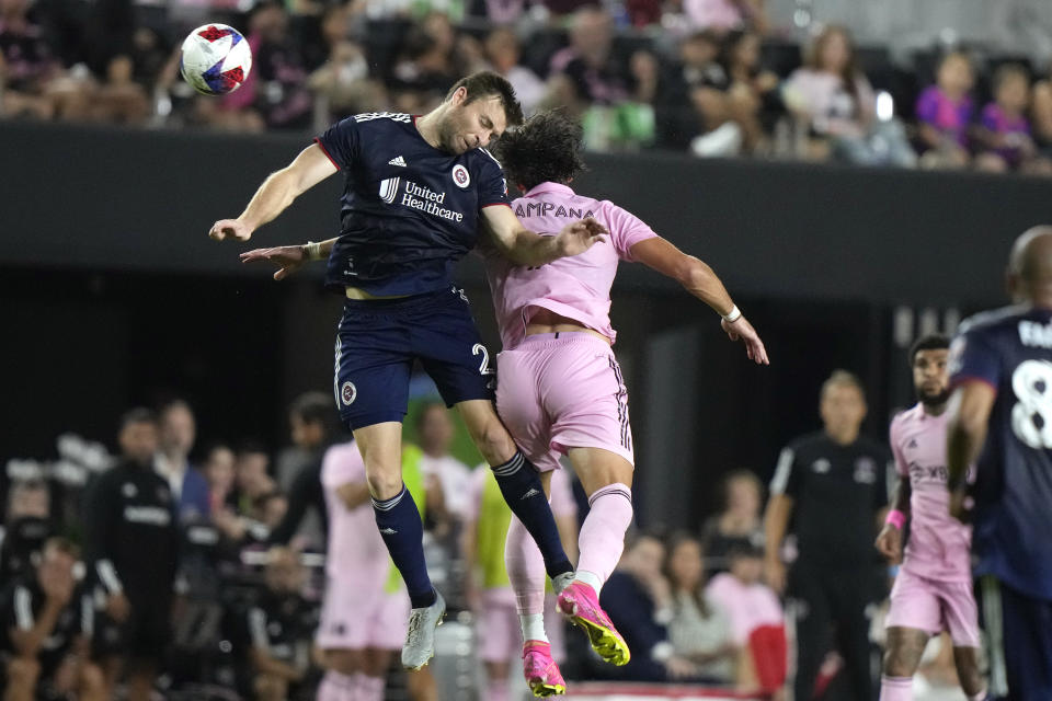 New England Revolution defender Dave Romney (2) heads the ball next to Inter Miami forward Leonardo Campana during the second half of an MLS soccer match Saturday, May 13, 2023, in Fort Lauderdale, Fla. (AP Photo/Lynne Sladky)